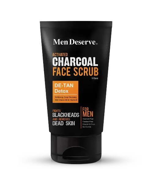 Men Deserve Activated Charcoal Face Scrub, which is intended for men's skin care. The packaging is predominantly black and orange, with text highlighting the product's benefits and target audience.