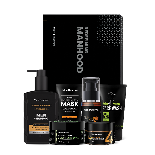 A Men's grooming kit including various hair and face care products such as shampoo, conditioner, face wash, and a grooming spray, packaged in black bottles and containers with the brand 'Men Deserve' displayed.
