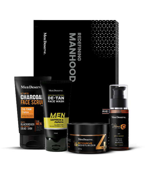 A collection of men's skincare products including a charcoal face scrub, tan removal facewash, brightening vitamin C serum, and hydrating SPF moisturizer, all branded under Men Deserve.