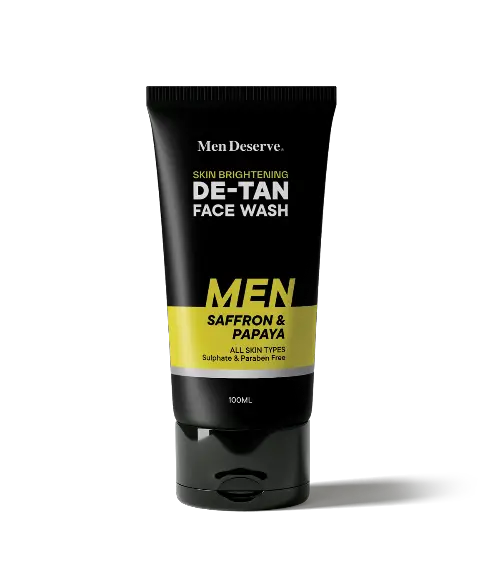 A tube of Men Deserve De-Tan Face Wash for Men, with black and yellow packaging, indicating it is a facial cleanser product.