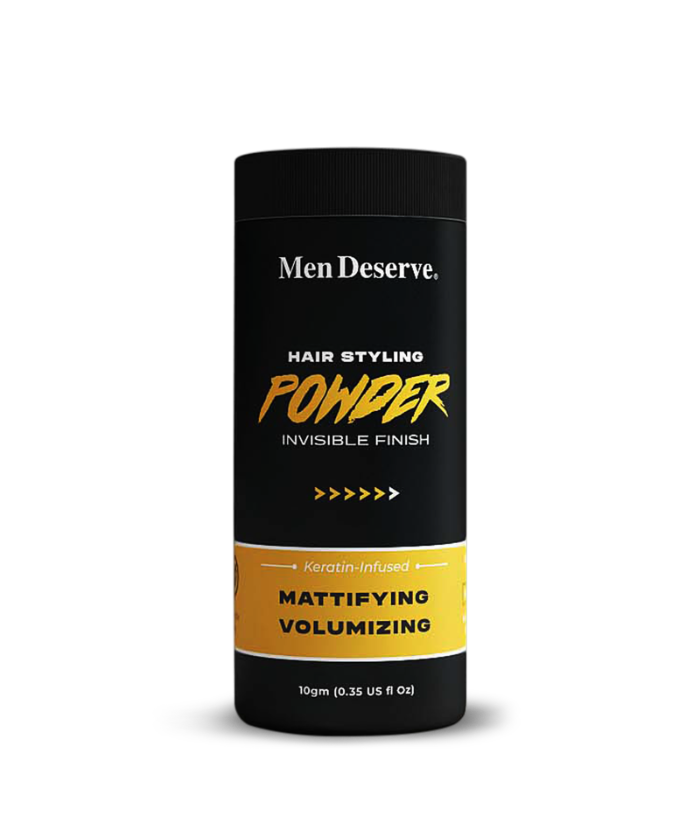 A canister of Men Deserve Hair Styling Powder with a matte finish, designed for volumizing and texturizing hair. The packaging is primarily black and yellow with text detailing the product's purpose and weight of 10gm.