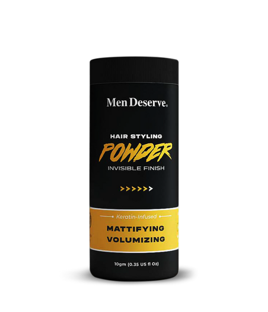 A canister of Men Deserve Hair Styling Powder with a matte finish, designed for volumizing and texturizing hair. The packaging is primarily black and yellow with text detailing the product's purpose and weight of 10gm.