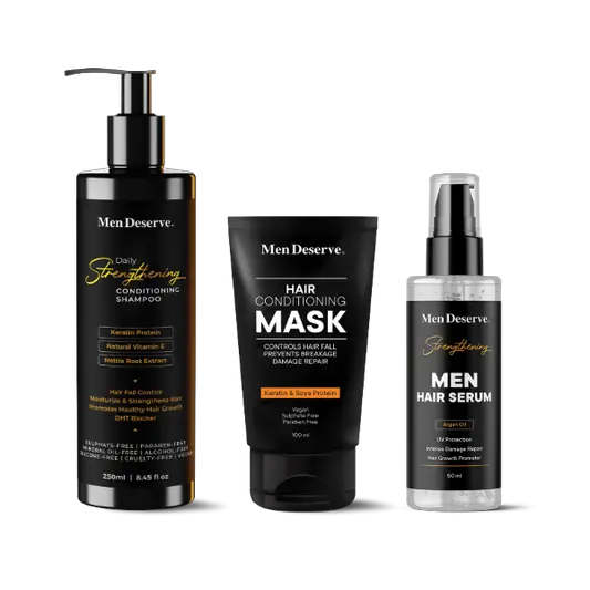A set of Men Deserve hair care products including a shampoo, conditioner, and hair serum, packaged in black bottles with white and orange labeling.
