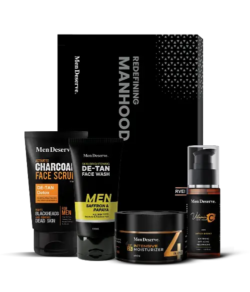 A collection of men's skincare products including a charcoal face scrub, tan removal facewash, brightening vitamin C serum, and hydrating SPF moisturizer, all branded under Men Deserve.