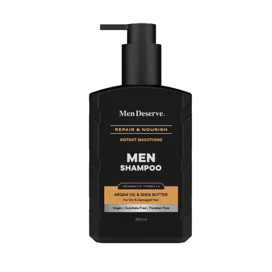 Black bottle of Men Deserve Men Shampoo with a pump dispenser, labeled as 'REPAIR & NOURISH' with white and gold text, indicating the product is for hair repair and nourishment.