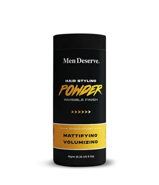 A canister of Men Deserve Hair Styling Powder with a matte finish, designed for volumizing and texturizing hair. The packaging is primarily black and yellow with text detailing the product's purpose and weight of 10gm.