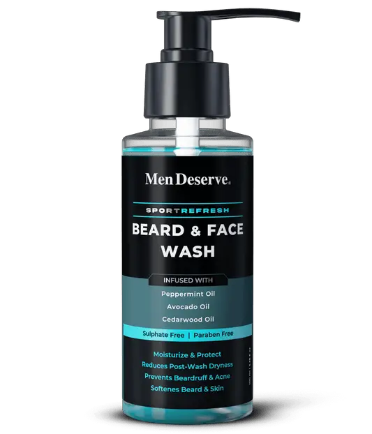 A bottle of Men Deserve Sport Refresh Beard and Face Wash with peppermint oil, cedarwood oil, and softener. The packaging is predominantly black and teal with white and red text, and includes an image of a beard.